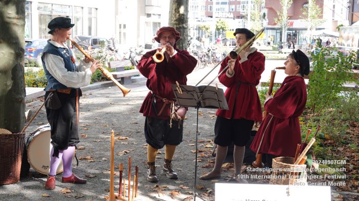 4 musicians dressed in historical clothing playing period instruments